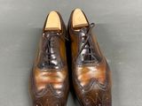 pair of men ' s brown leather shoes with laces on them