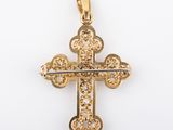 a yellow gold cross pendant with diamonds on a white background