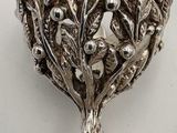 a silver plate with a tree on top of it