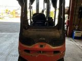 a forklift truck parked in a garage next to a building