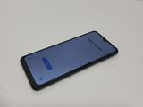 a close up of a cell phone sitting on a table