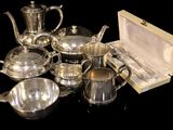 silver plated tea and coffee set in a box on a black surface