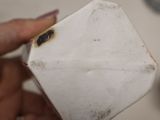 a person holding a small white object in their hand