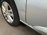a close up of a car ' s tire on the side of the road