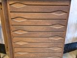 an image of a wooden cabinet with a surfboard on top of it