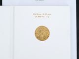 a close up of a book with a gold coin on top of it