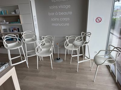 four chairs in a room with a sign on the wall