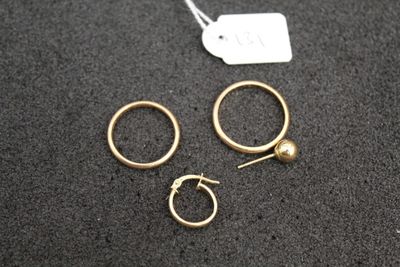 three pairs of gold hoop earrings and a gold ball earring