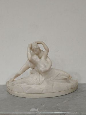 a statue of a woman sitting on top of a table