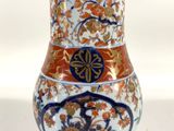 a vase that is sitting on a white surface