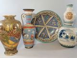 four vases sitting next to each other on a table
