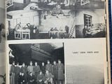 an open book with black and white photos of a group of people