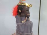 a small statue of a person in a glass case