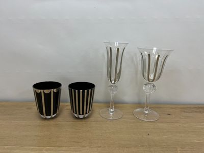 three wine glasses sitting on a table next to each other