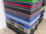 stack of plastic pallets stacked on top of each other in a warehouse