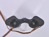a pair of binoculars that are sitting on a white surface