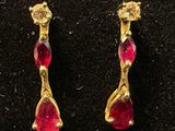 a pair of gold earrings with rub rub rub rub rub rub rub rub rub rub rub rub rub rub rub