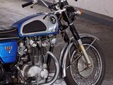 a blue and black motorcycle parked in a garage