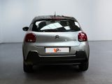 a silver car that is parked in a room