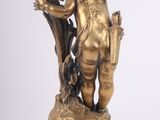 bronze statue of a cupid holding a bird on a pedestal