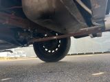 a close up view of a car ' s rear end on the road