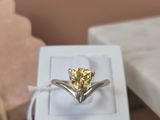 a yellow diamond ring in a white box on a table