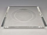 rectangular clear glass plate with a circular design on the edge
