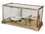 a glass display case with a barometer inside of it