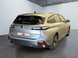 a silver car parked in a room with a black floor