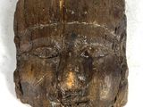 an image of a wooden head with a face carved into it