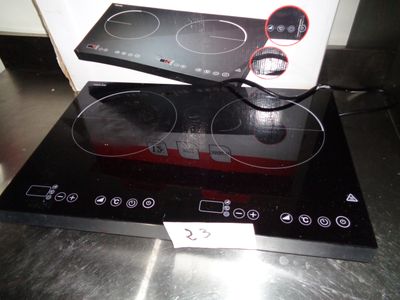 a black stove top with two burners on it
