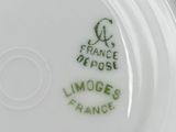 a close up of a white plate with a green design on it