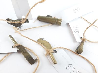 a bunch of old brass items on a white table