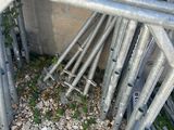 a pile of metal pipes that are next to a building