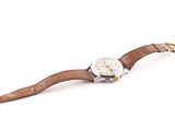 an image of a watch with a brown leather strap on a white background