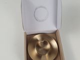 a gold plate in a cardboard box on a table