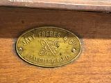 a close up of a brass plate on a wooden table