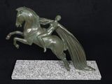 statue of a horse with a rider on its back on a marble base