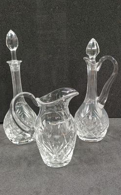 three glass vases sitting on a table next to each other