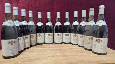 bottles of wine lined up on a wooden table with a red background