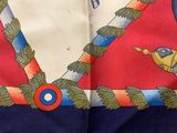 a close up of a scarf on a wooden table