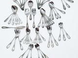 a lot of silver spoons and forks arranged in a circle