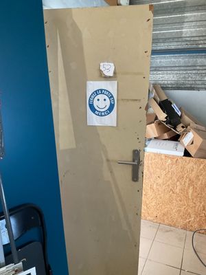 a refrigerator with a sticker on it in the corner of a room