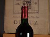 a bottle of wine sitting on a table next to a box