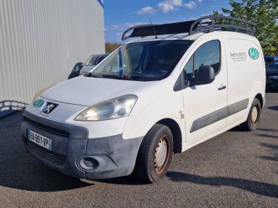 a white van parked in a parking lot next to a building