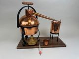an image of a copper pot on a wooden stand with a needle