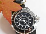 a black watch with a black face and a red leaf on it