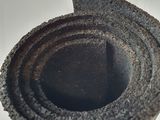 a rolled up roll of cement on a white surface