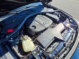 the engine of a blue car with its hood open