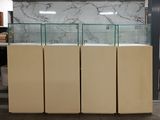 a lot of glass cases that are in a room